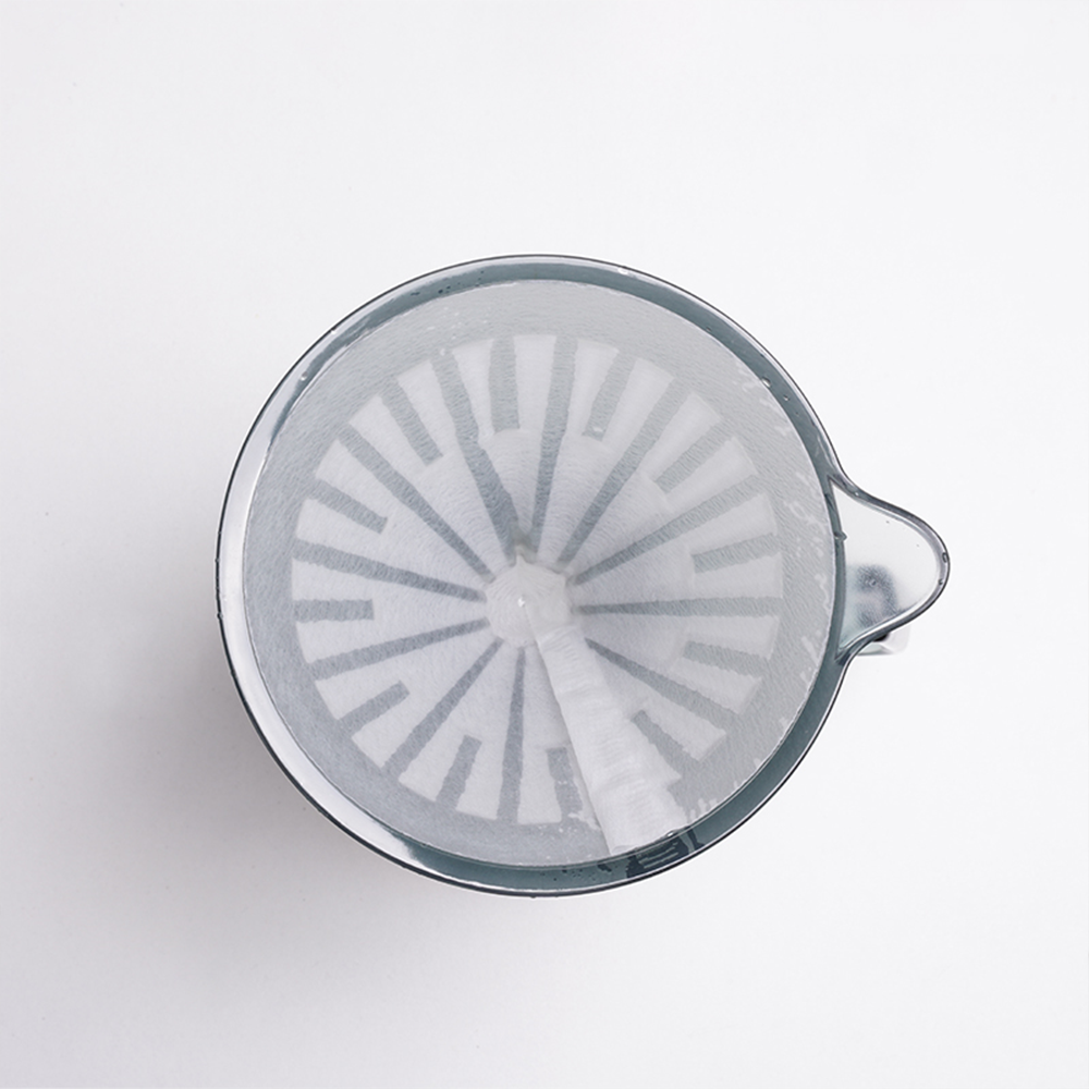 Crystal Eye Dripper 02 seated on a coffee server mid-brew