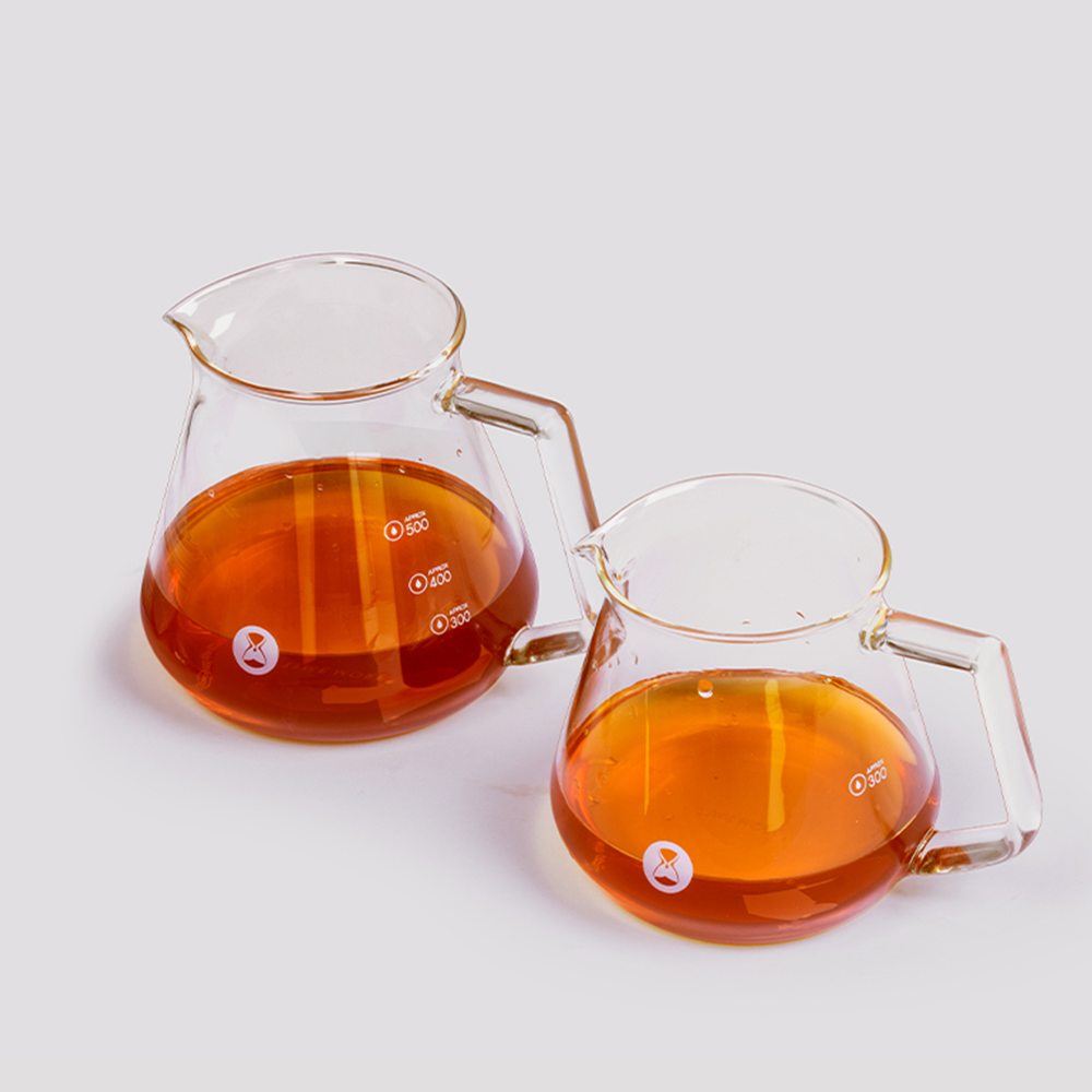 Clear glass server filled with brewed coffee, volume level visible